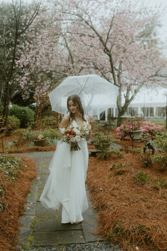 bride in spring garden with clear umbrella