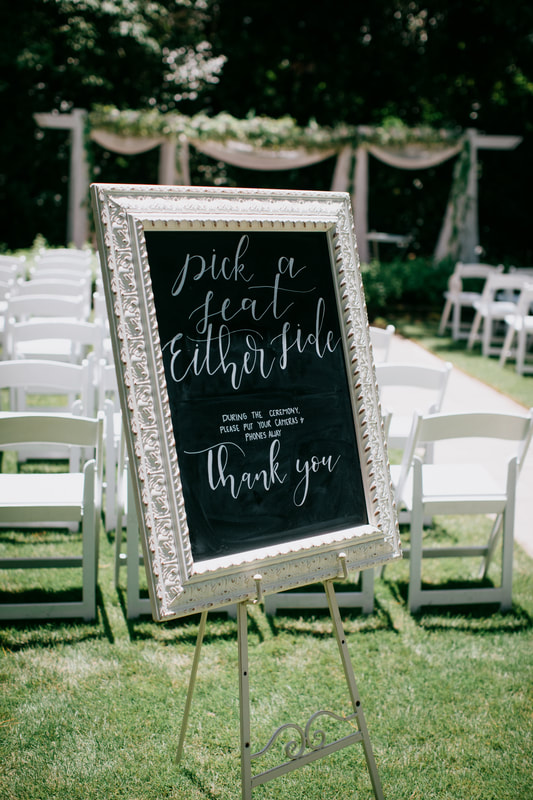 'pick a seat either side' ceremony chalk board sign