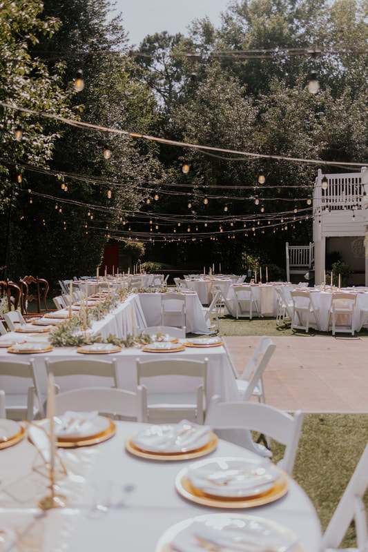 backyard reception with white tables and dance floor