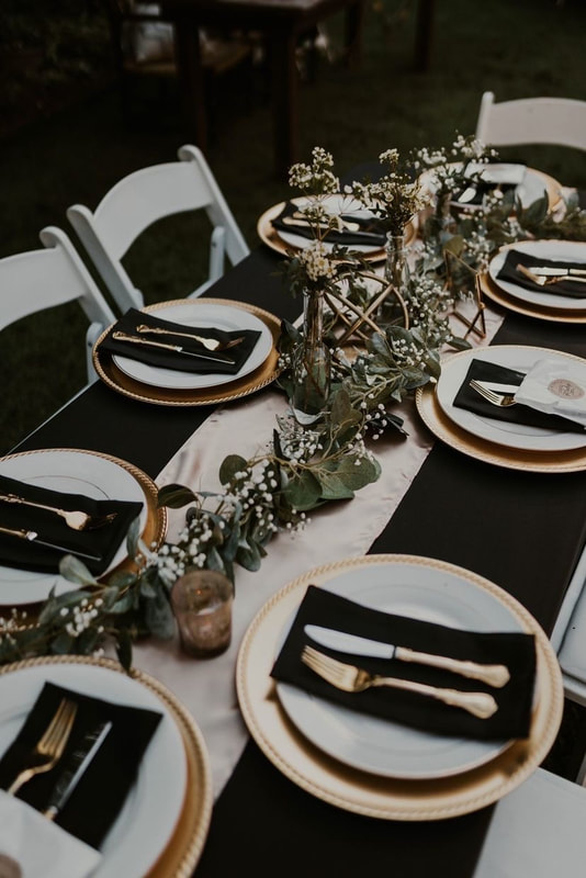 celestial themed wedding tables with black and gold decor