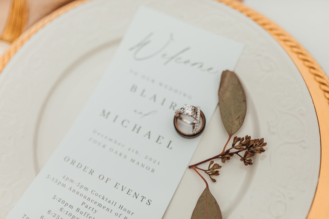 wedding timeline and wedding bands on white china plate