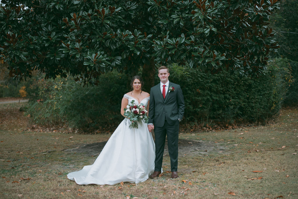 november newlyweds in front of magnolia