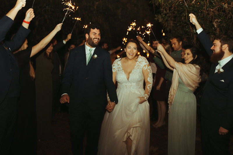 bride and groom laughing during sparkler grand exit