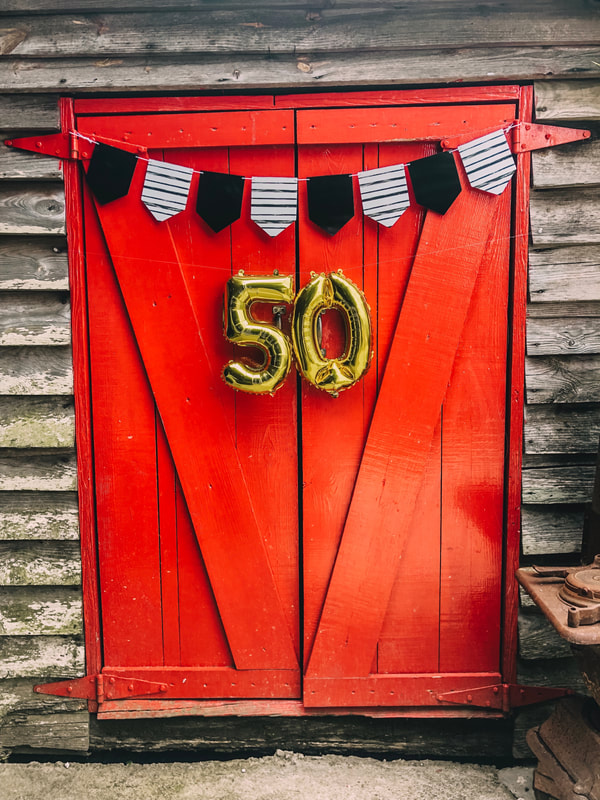 50th anniversary decorations on red barn door