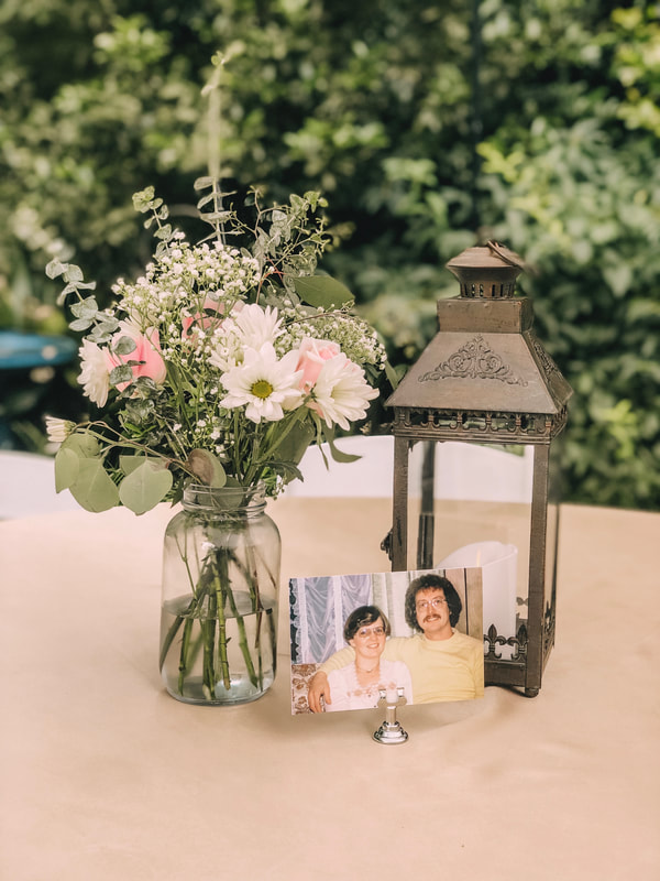 couple photos with flower arrangements and lantern centerpiece