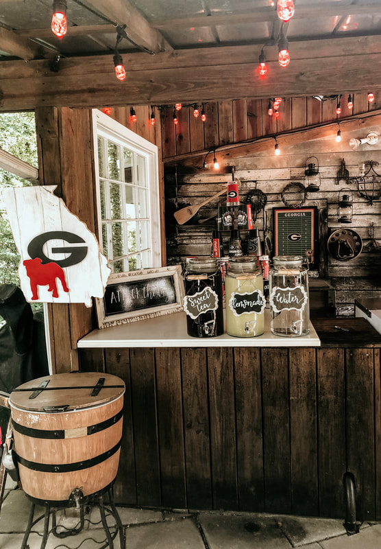 drink station setup at smokehouse with UGA decorations