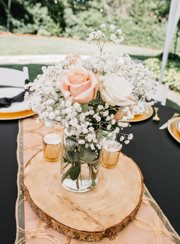 Peach and white flower centerpiece on wood slice