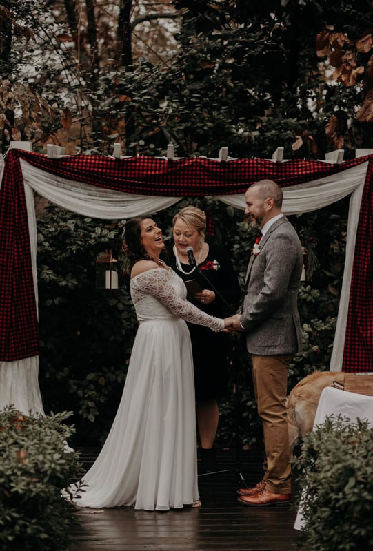 bride laughing at altar decorated with buffalo plaid fabric
