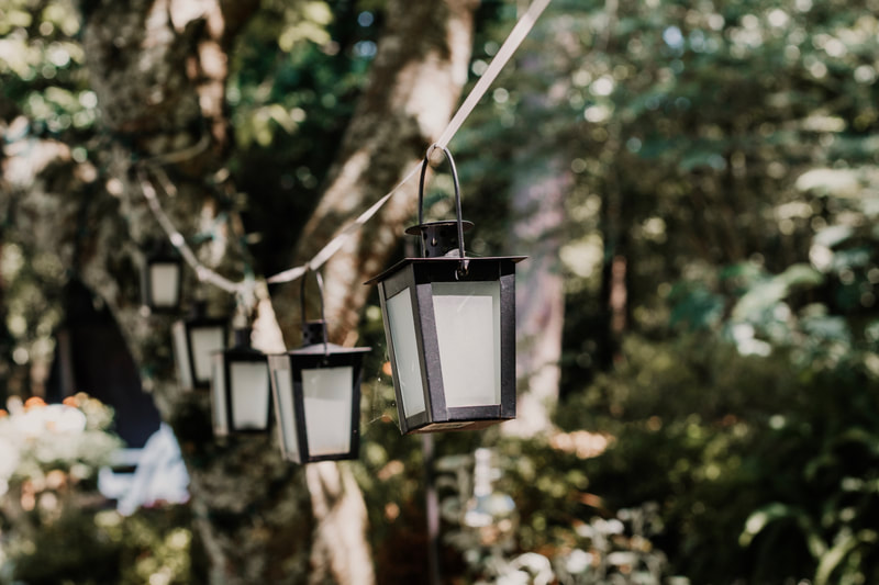 small, oiled bronze lanterns hanging from ribbon