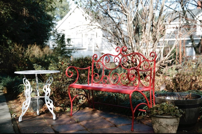 Four Oaks Manor's red bench and white table