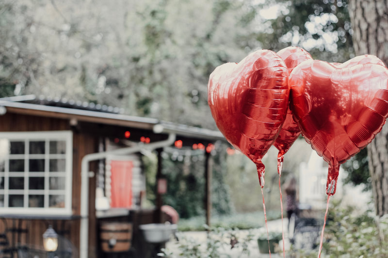 Four Oaks gardens decorated for Valentine's Day with heart balloons and red lights