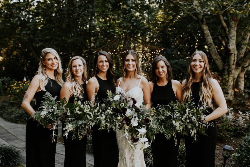 boho bride with bridesmaids in black dresses