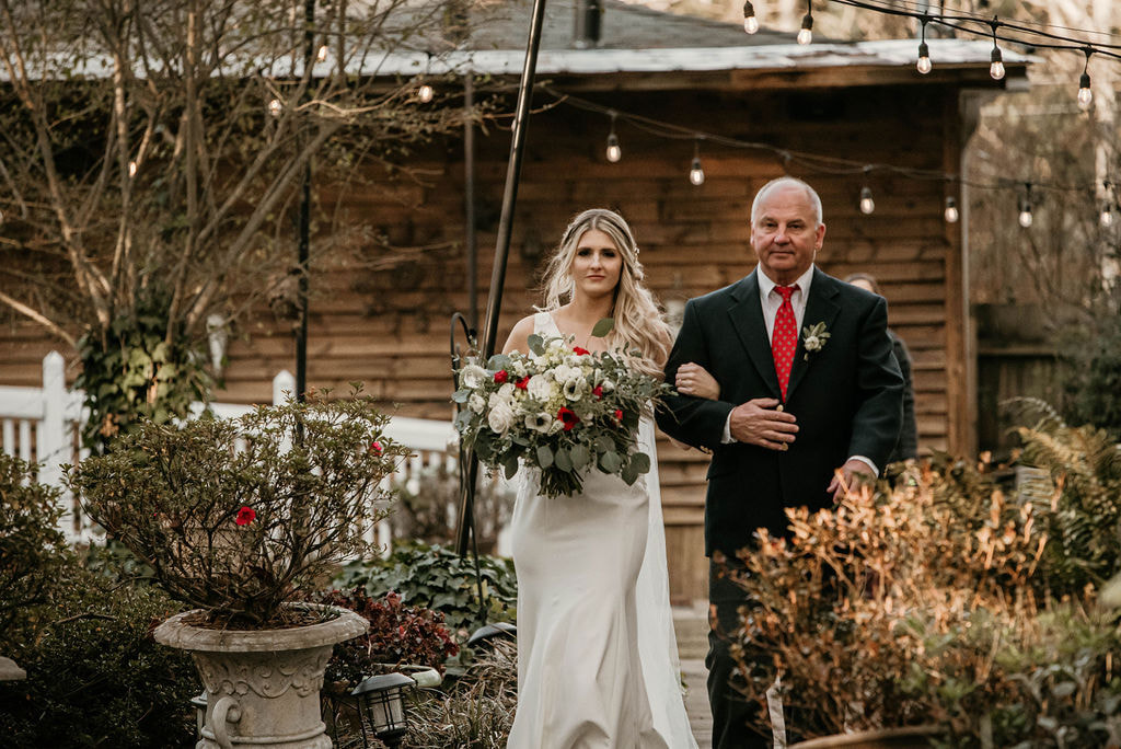 Dad walking bride down the aisle for outdoor wedding ceremony in December. 