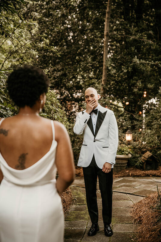 groom's reaction to bride during first look in garden