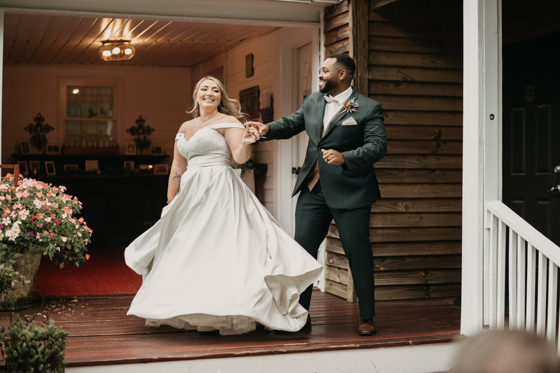 groom twirls bride on back porch