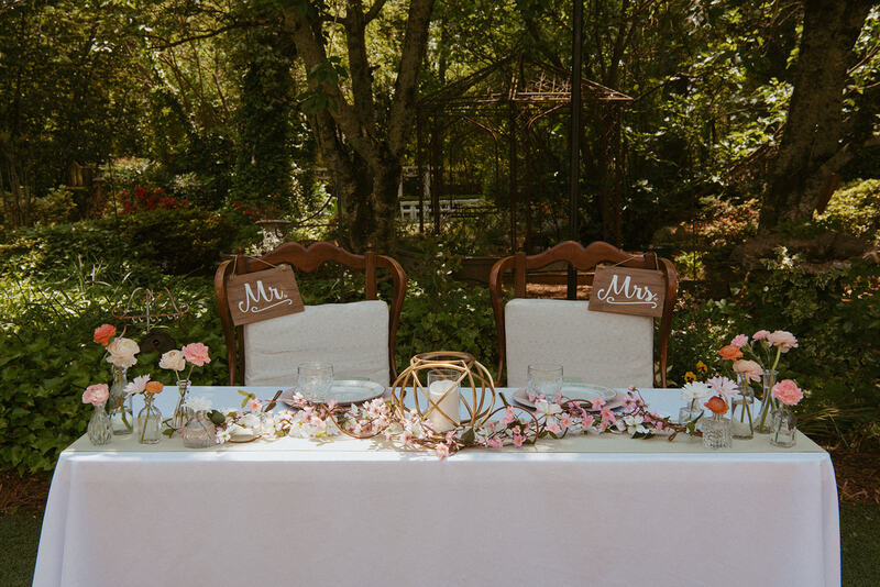 floral head table with cherry blossom garland