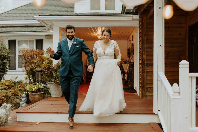 bride and groom walking down red porch steps during announcement