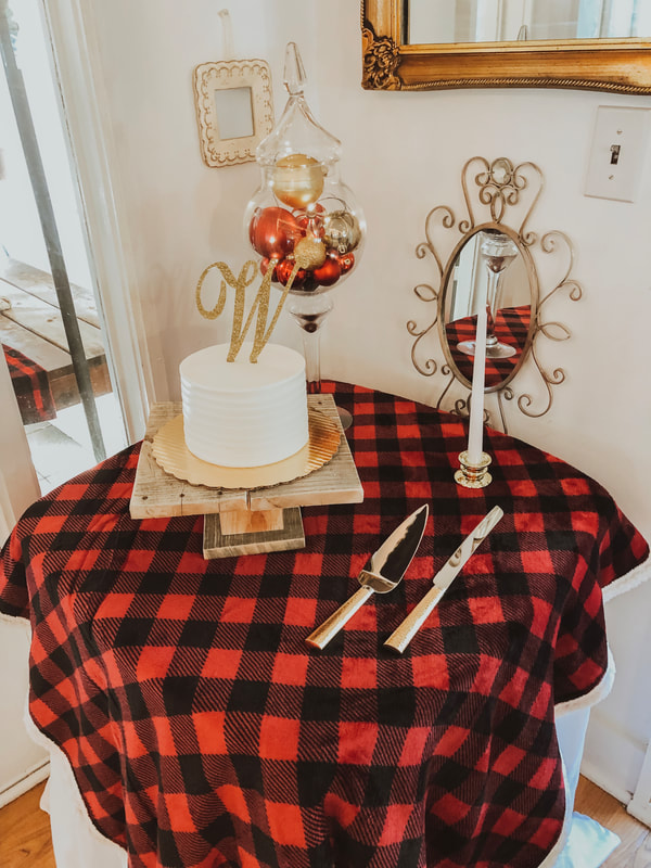 christmas themed cake table with red plaid and gold ornaments